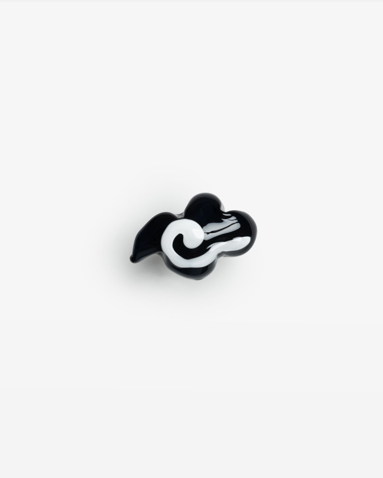 Kumori Ring handcrafted in black and white borosilicate glass, featuring a unique cloud-shaped design against a white background. The artistic piece shows swirling patterns in a minimalist monochromatic style.